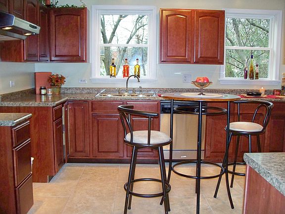 New kitchen features custom cabinets and real Travertine stone floors