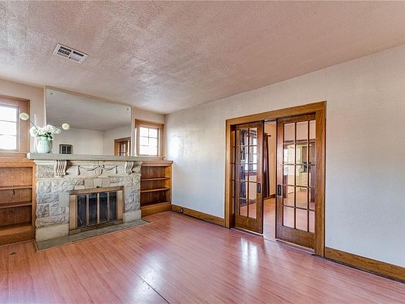 Gorgeous custom fireplace and built ins! This pocket door dividing the living room and dining is to die for!