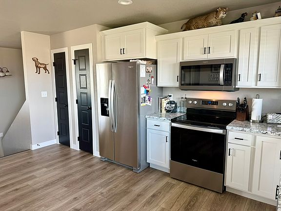 Kitchen, with pantry off to the left of the refrigerator.