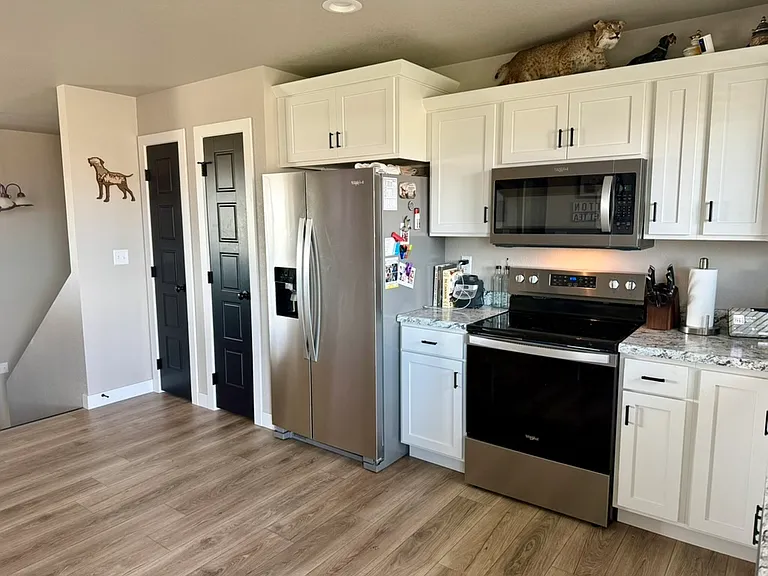 Kitchen, with pantry off to the left of the refrigerator.