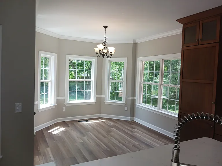 Spacious eat-in area off kitchen leads to back deck.