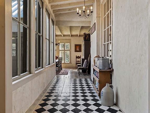 The painted wood floors in this galley that connect the primary suite and the living areas is so picturesque. 