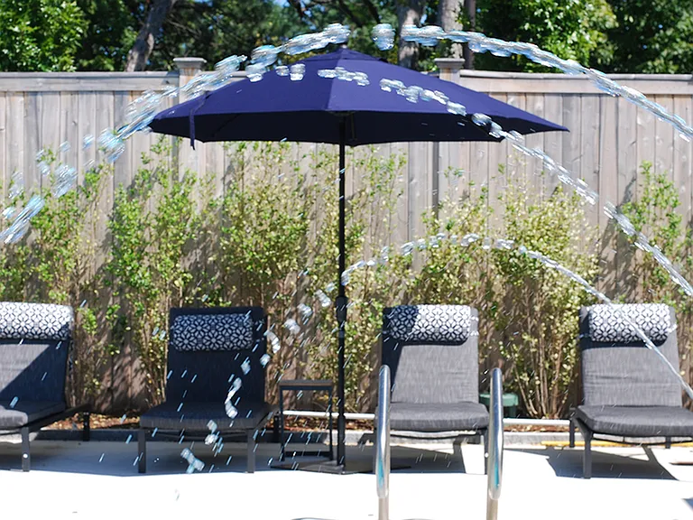 Pool-Side Deck Featuring Lounge Chairs and Shade Umbrellas
