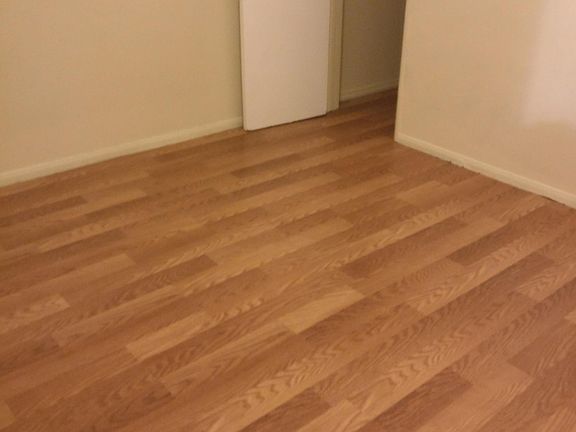 Spacious bedroom with walk in closet all with new laminate flooring .