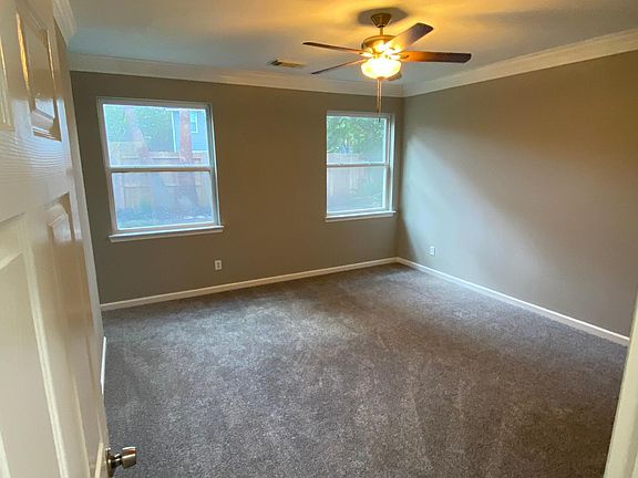 Master bedroom with windows to the back yard