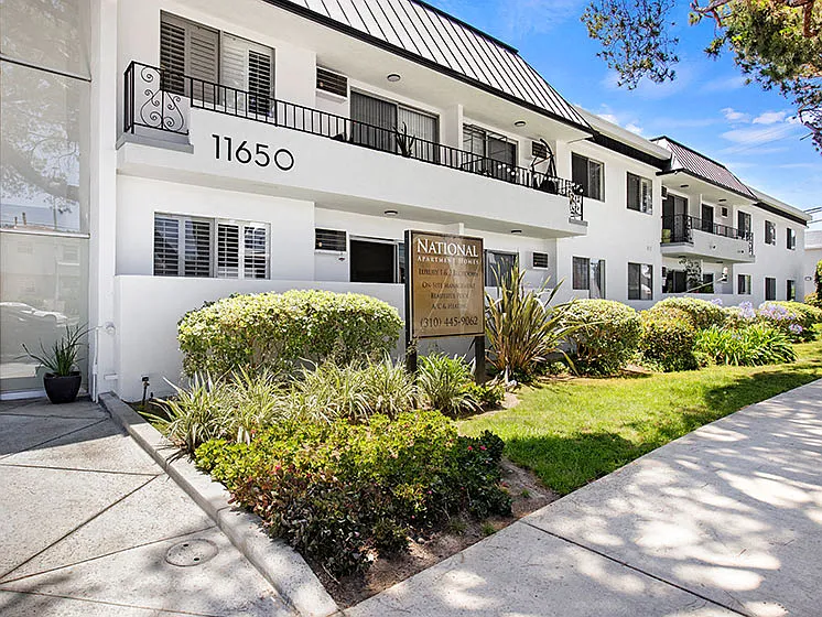 Entrance to National Apartments with drought-resistant greenery.