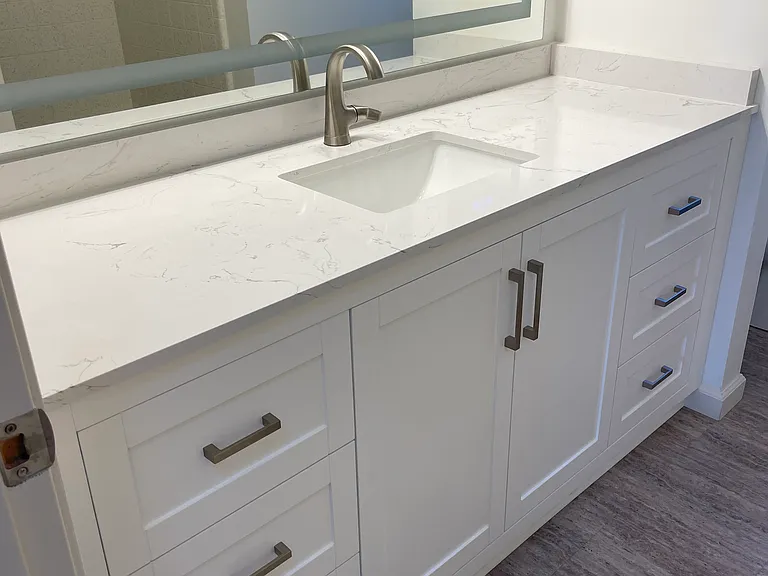 Brand new bathroom Vanity with marble counter top and new, large lighted vanity mirror.