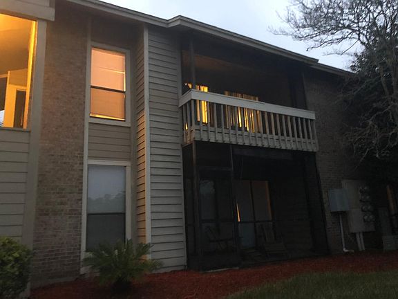 Screened in back patio facing beautiful pond with water foun