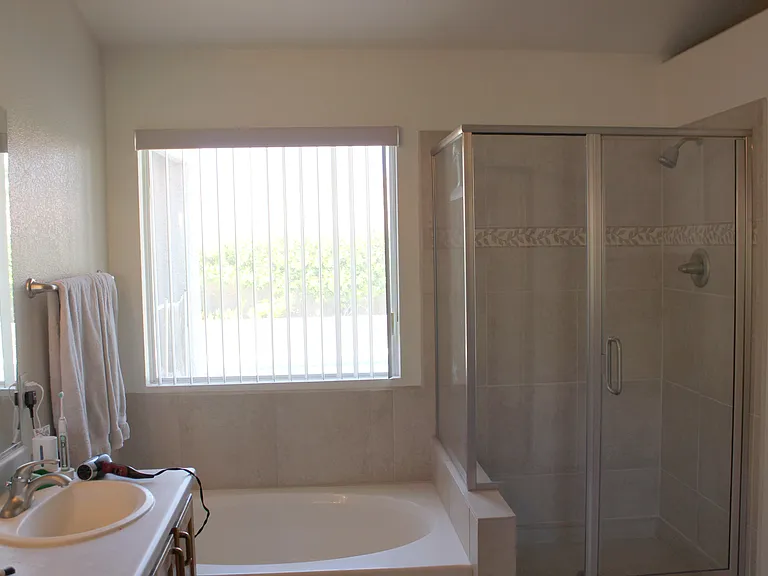 Bedroom #1 - Mater bath with window looking out on pool.