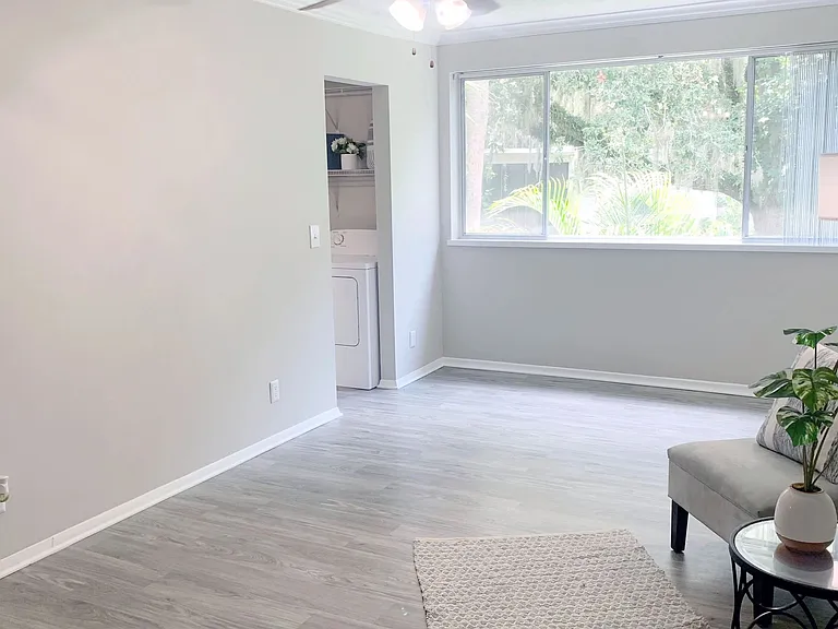 Savor our studio's captivating open living space, abundant with natural light from a grand window and complemented by the gentle breeze of a lighted ceiling fan.