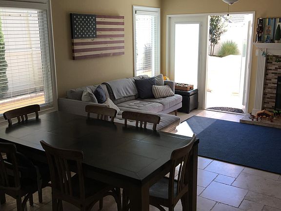 Kitchen opens into a family room and has direct access to the backyard. Overhead lighting and ceiling fan.