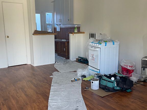 Living area to kitchen. Stove will be put in kitchen. New stove.