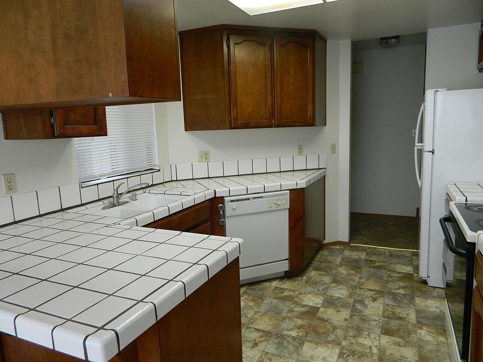 Kitchen includes oven/stove, refrigerator, dishwasher and microwave with ample counter space.