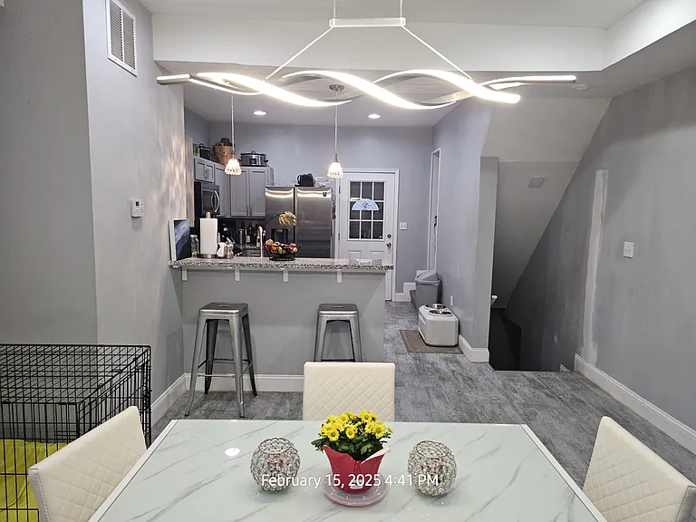 Veiw of beautiful clean kitchen and entrance to basement unit
