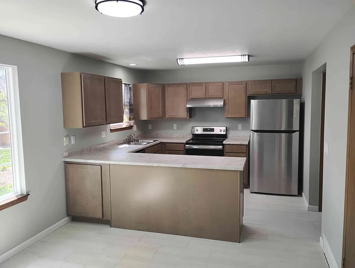 New kitchen cabinets, countertops, fridge, range hood, sink/faucet. - 9411 Dew Drop Ct