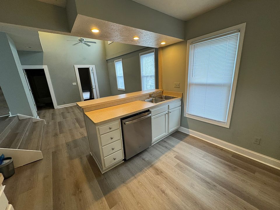 Kitchen with living area with high ceilings in background, new dishwasher
