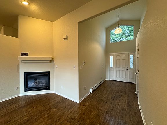 View of entry with gas fireplace and mantel.