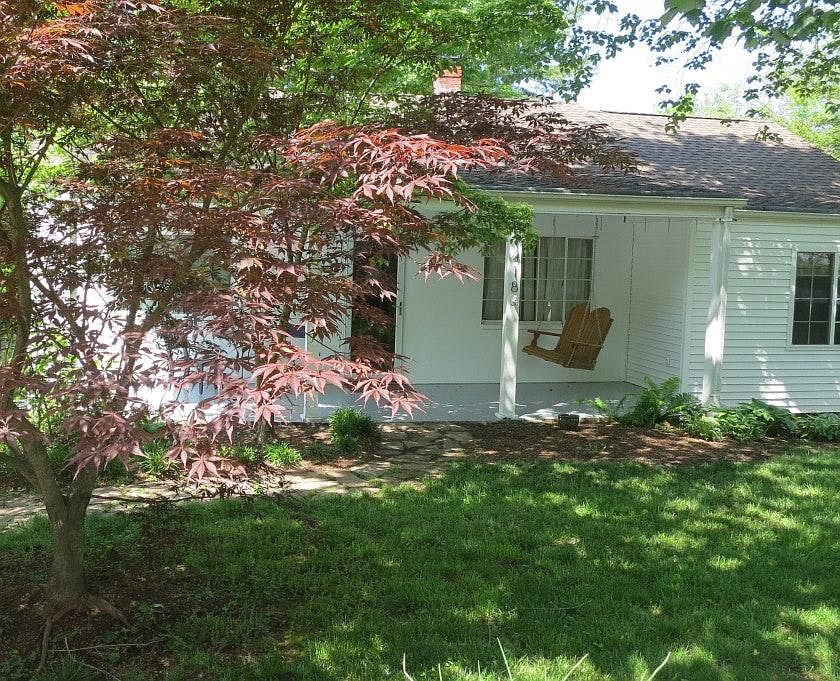 Beautiful trees and a large yard surround this updated and roomy home with an open floorplan.