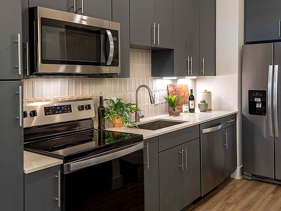Add a touch of sophistication to your kitchen with the stylish tile backsplash at Modera Garden Oaks.