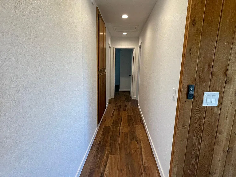 Hall to restroom and 2 bedrooms.