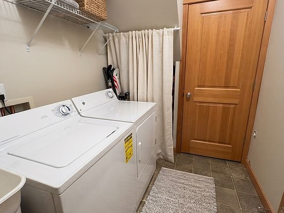 Laundry room - Tons of storage under the stairs behind the curtain