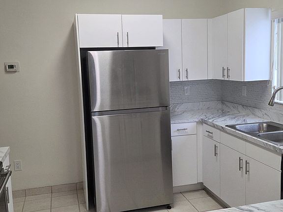 Kitchen, new stove, microwave, and dishwasher. Refrigerator has icemaker.