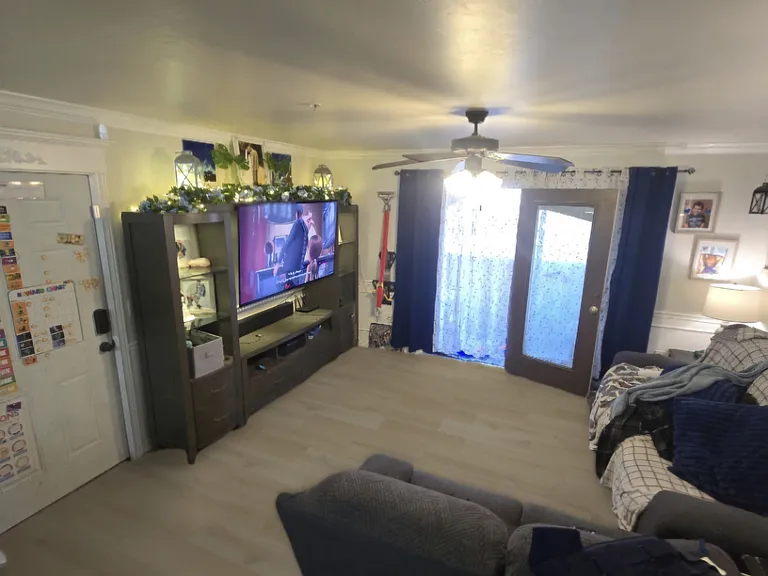A view of the living room, the brand new flooring, and the patio access.
