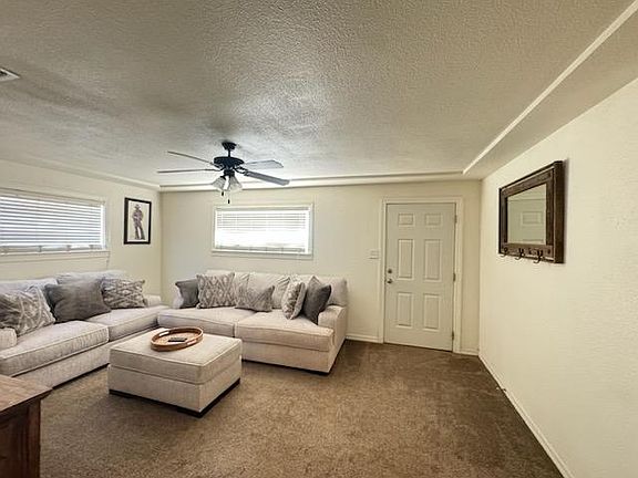 Living room and front door. Door faces west.