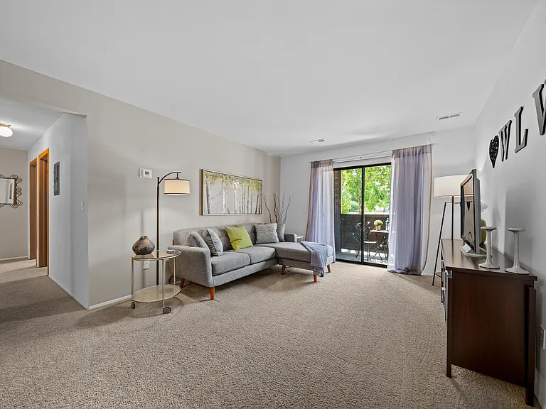 Cozy living room with natural light at Woodland Villa Apartments in Westland, MI.