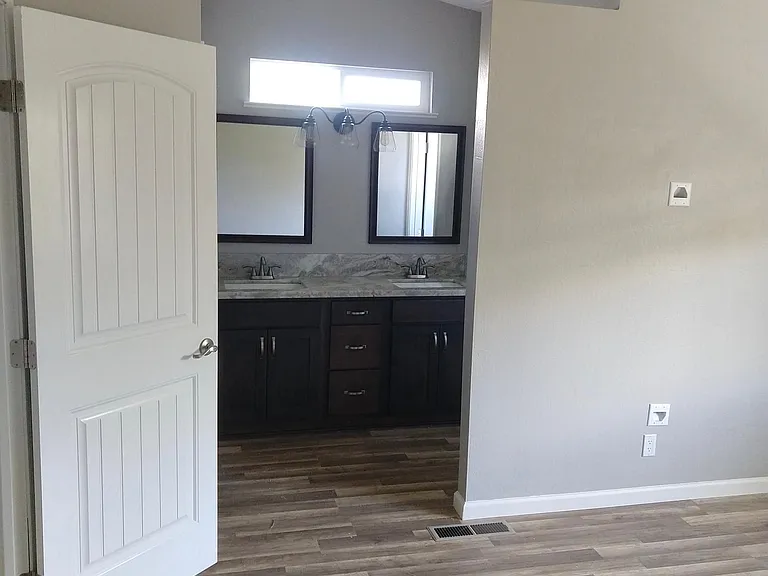 Master bedroom bathroom on right and closet on left side of vanity