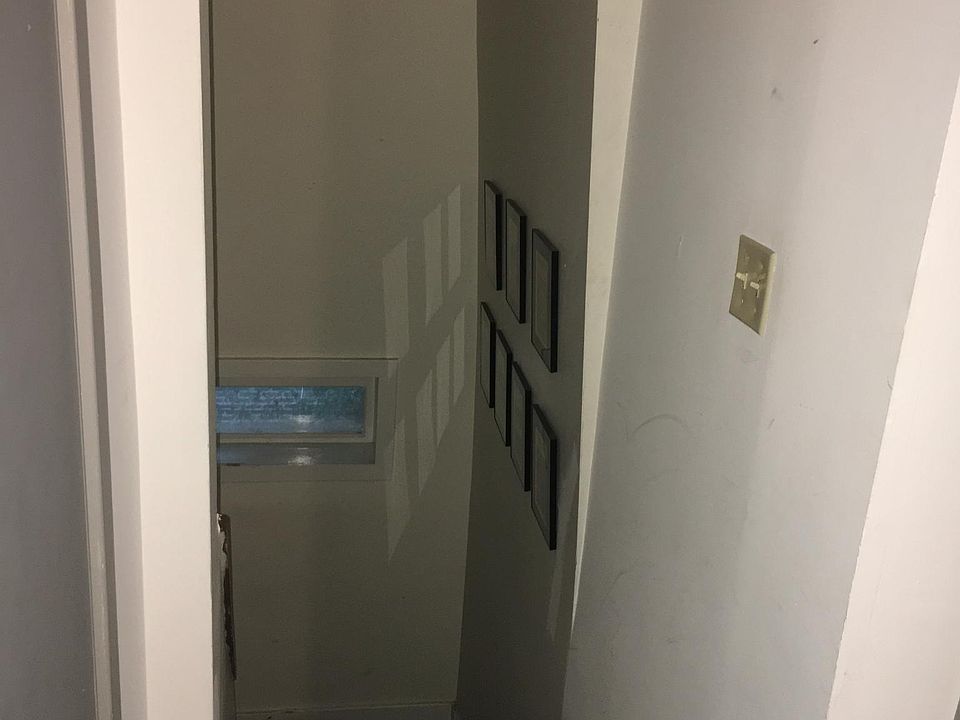 Stairs looking down from unit to second floor landing.