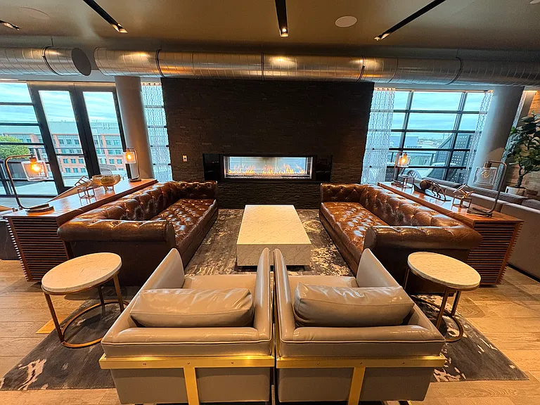 Additional view of the clubhouse lounge, complete with fireplace.