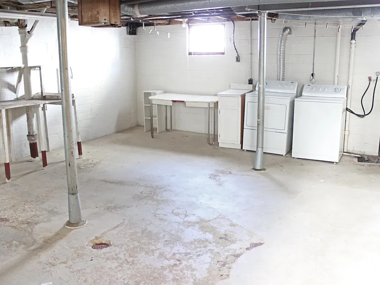 Basement washer, dryer, and storage space. Laundry chute from bathroom to basement
