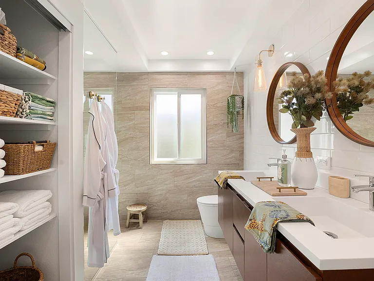 Primary en-suite spa bathroom with rain shower and double vanity.