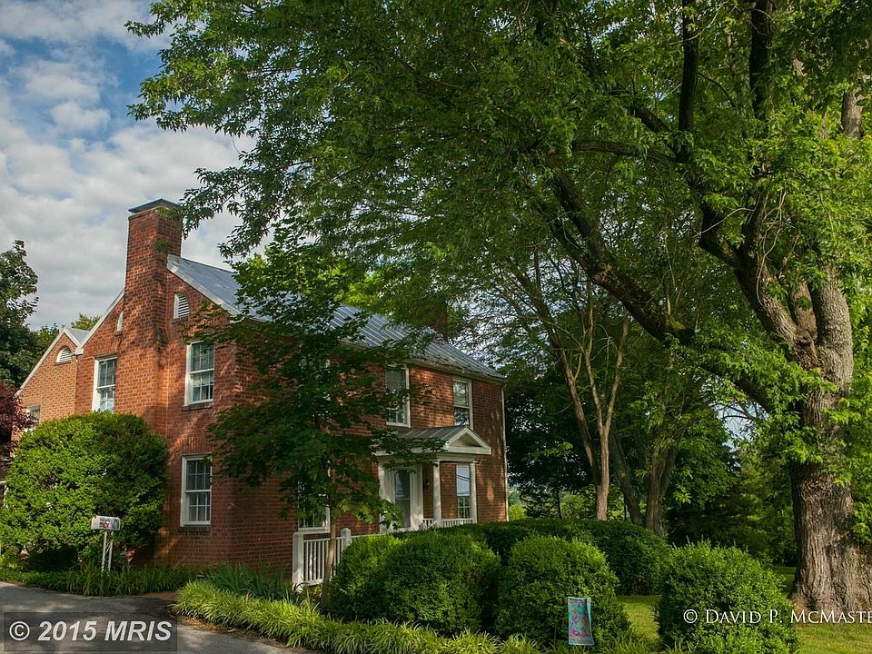 Classic 1853 brick colonial expanded on 2 acres.