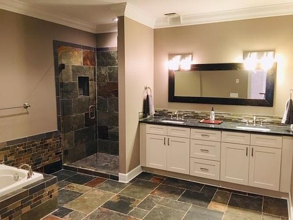 Huge slate bathroom with granite counter top. Plenty of room for your toiletries in double sized vanity.
