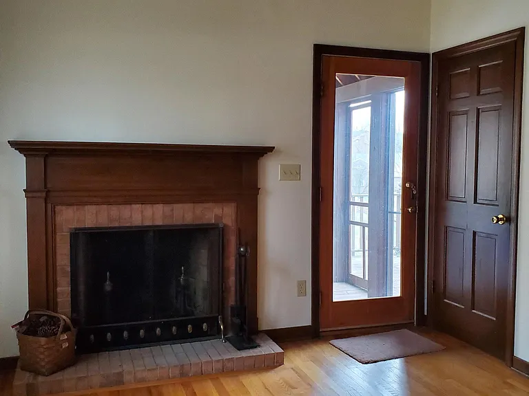 Fireplace in kitchen, entrance to screened in porch/ covered deck
