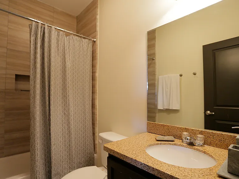 Merida Vista Apartments in Laredo, TX - Interior Bathroom with Shower, Washroom, and Toilet