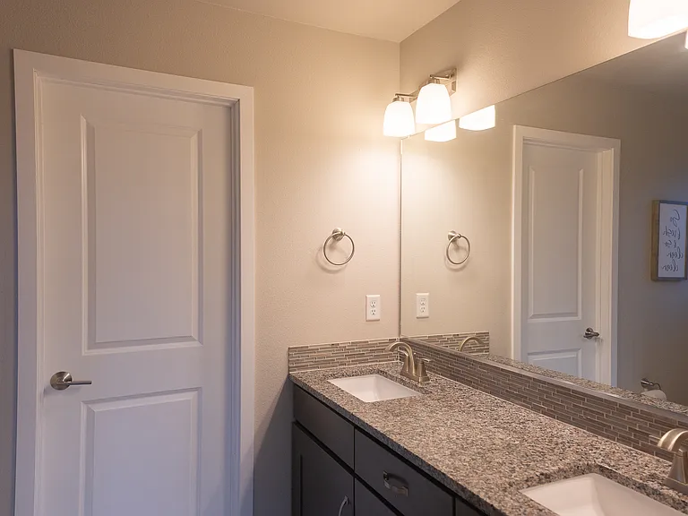 Master bath - door leads to walk-in closet (custom-built California Closets)