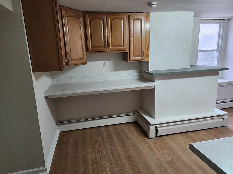 Kitchen work area with extra cabinets and bluestone bar area