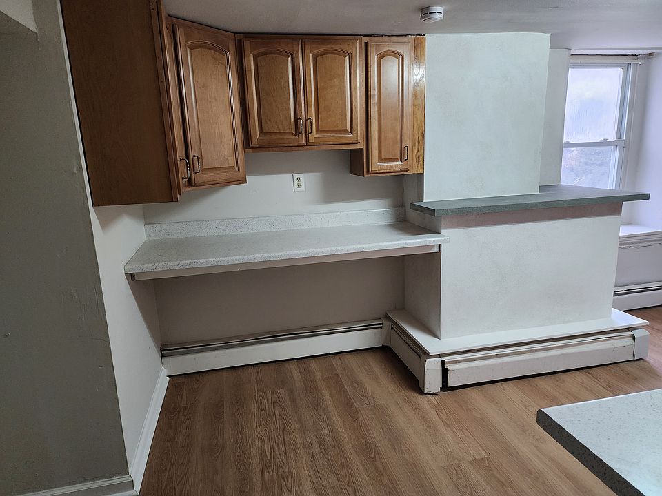 Kitchen work area with extra cabinets and bluestone bar area