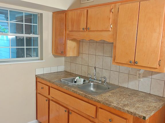 The kitchen is large and leads outside to a garden.