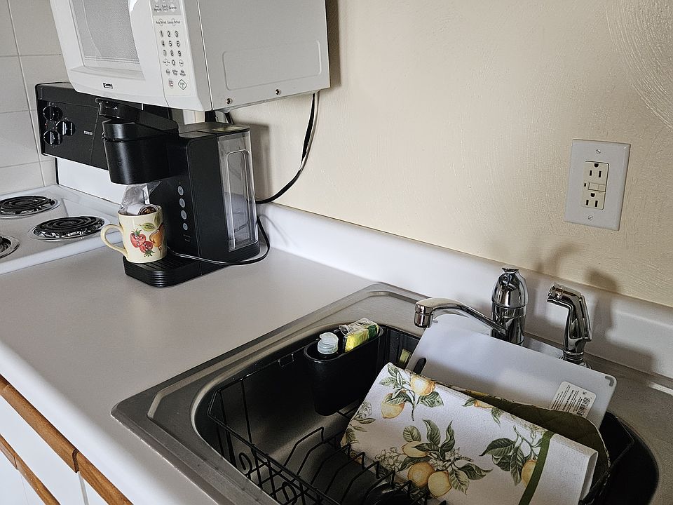 Modern kitchen with Keurig, pots and pans, utinsils