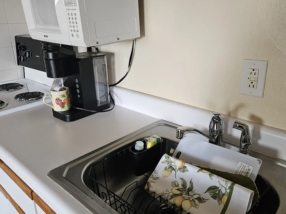 Modern kitchen with Keurig, pots and pans, utinsils