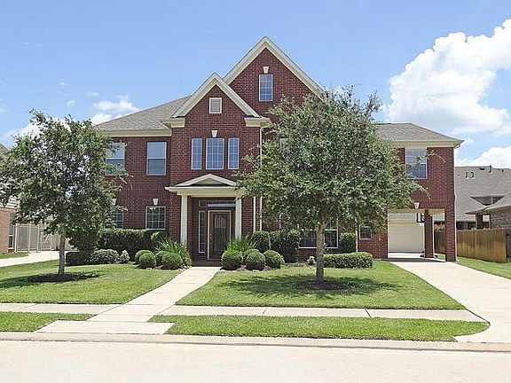  Detached garage with wonderful porte cochere - a covered pass-thru for a car before it goes to the garage. Garage door face away from house, side of garage looks like the house.