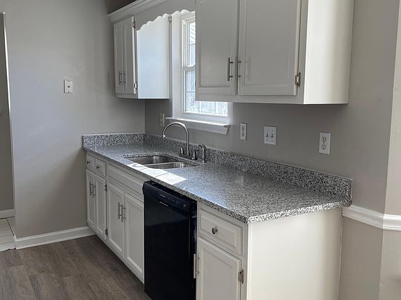 Kitchen with brand new sink and granite countertops.