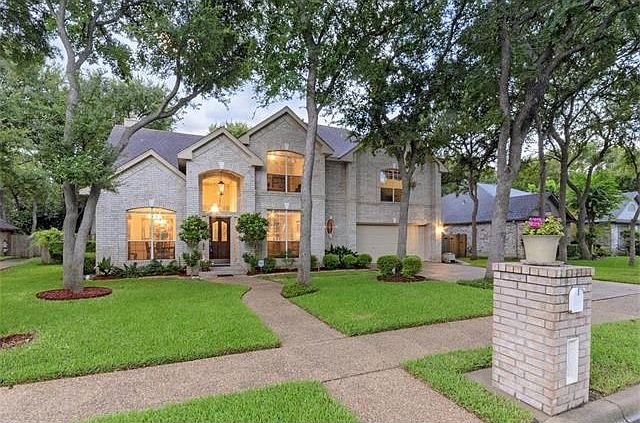 This traditional two-story home has a white brick masonry front with white brick on first level sides and then wood siding. It has a carefully balanced floor plan with the master suite on the first level. Exceptionally built and has been a well maintained