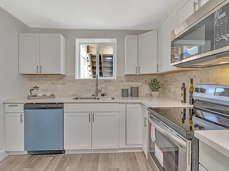 Kitchen with new appliances and fixtures.