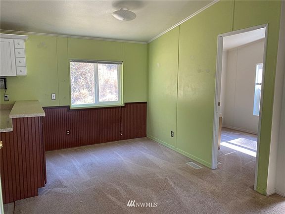 view from living room to dining room, kitchen to left, office to right