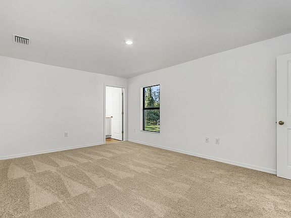 The master bedroom is spacious with plenty of natural light